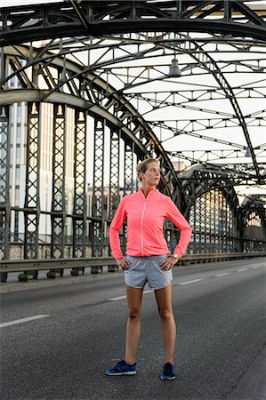 roadway and city - Young female runner exercising on bridge Stock Photo - Premium Royalty-Free, Code: 649-07520920