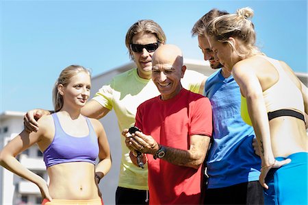 simsearch:649-07520875,k - Mature male trainer and a group of adult runners Stock Photo - Premium Royalty-Free, Code: 649-07520940