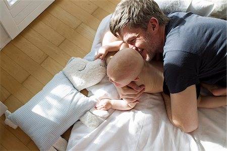 smiling baby pictures - Father playing with baby daughter Stock Photo - Premium Royalty-Free, Code: 649-07520972