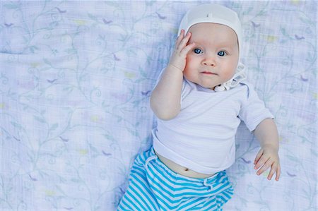 front of face looking down - Portrait of baby girl touching face Stock Photo - Premium Royalty-Free, Code: 649-07521008