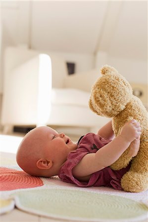 Baby girl playing with teddy bear Stock Photo - Premium Royalty-Free, Code: 649-07521003