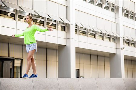 Young woman walking on wall Stock Photo - Premium Royalty-Free, Code: 649-07521068