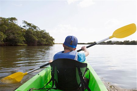 Young boy paddling canoe on tranquil river Stock Photo - Premium Royalty-Free, Code: 649-07521081