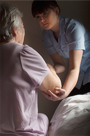 Personal care assistant helping senior woman to get up Stock Photo - Premium Royalty-Free, Code: 649-07521169