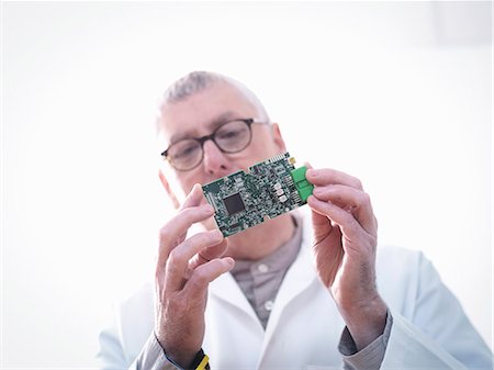 Engineer inspecting electronic circuitry for automotive use Stock Photo - Premium Royalty-Free, Code: 649-07521181