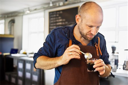 simsearch:649-06622991,k - Male barista stirring coffee glass in coffee bar Stock Photo - Premium Royalty-Free, Code: 649-07559781