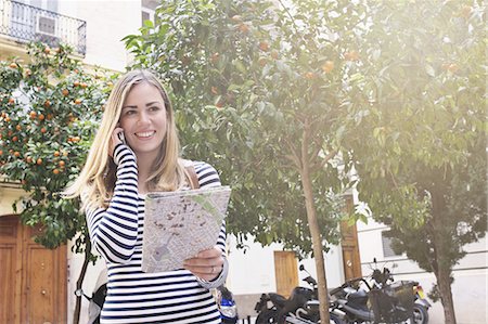 smile woman urban europe - Young female tourist with map and cellphone, Valencia, Spain Stock Photo - Premium Royalty-Free, Code: 649-07560078