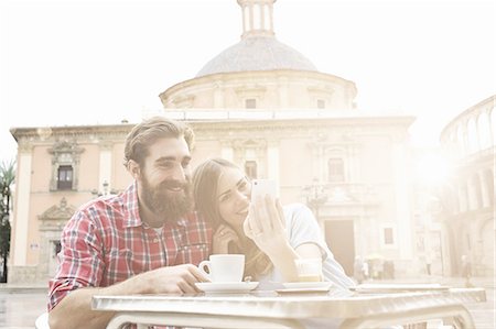 friendship travel adult - Young couple having coffee in sidewalk cafe, Plaza de la Virgen, Valencia, Spain Stock Photo - Premium Royalty-Free, Code: 649-07560108