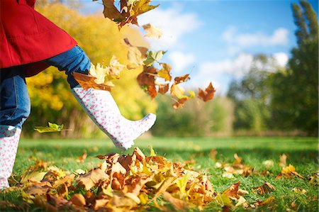 people rubber boots - Cropped shot of mature woman kicking autumn leaves in park Photographie de stock - Premium Libres de Droits, Code: 649-07560363