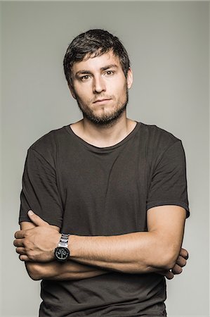 portrait people grey background - Studio portrait of young man in black tshirt Stock Photo - Premium Royalty-Free, Code: 649-07560395