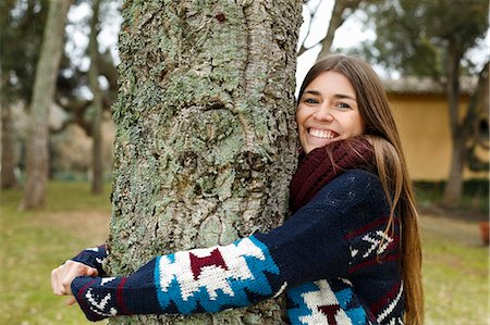 person hugging tree - Young woman hugging tree in forest Stock Photo - Premium Royalty-Free, Code: 649-07560404