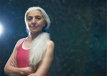 Mature woman with long grey hair wearing pink vest Stock Photo - Premium Royalty-Free, Code: 649-07560460