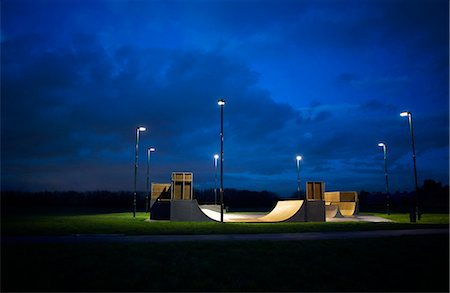 risk - Skateboard park surrounded by a circle of lights at night Stock Photo - Premium Royalty-Free, Code: 649-07560495