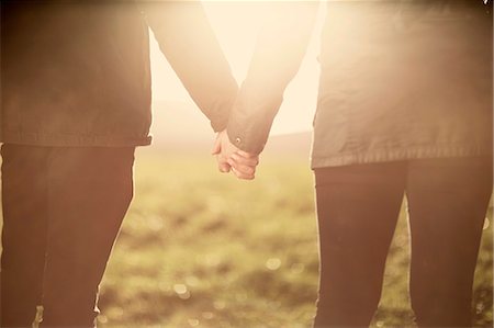 romantic couple holding hands - Mid section of couple, holding hands Stock Photo - Premium Royalty-Free, Code: 649-07560513