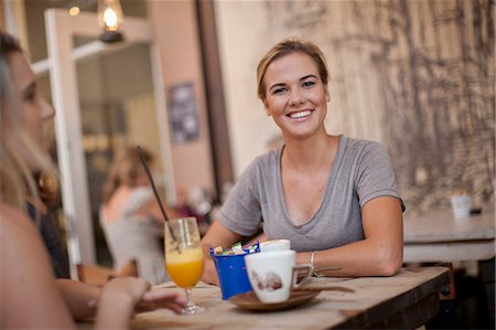 drinking straw not child - Two young adult female friends enjoying a chat in cafe Stock Photo - Premium Royalty-Free, Code: 649-07585062