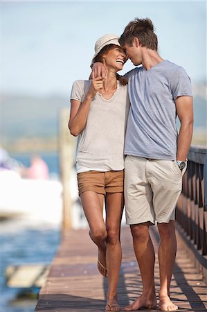 relaxing on a dock - Young couple walking along jetty, arms around each other Stock Photo - Premium Royalty-Free, Code: 649-07585227