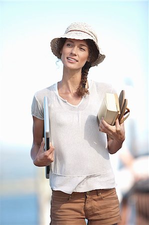 people and lake and reflection - Portrait of young woman holding book, sandals and laptop Stock Photo - Premium Royalty-Free, Code: 649-07585228