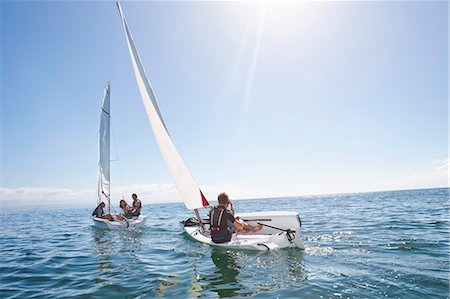 Young adult friends racing each other in sailboats Photographie de stock - Premium Libres de Droits, Code: 649-07585250