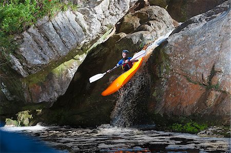 safety equipment - Mid adult man kayaking down river waterfall Stock Photo - Premium Royalty-Free, Code: 649-07585294
