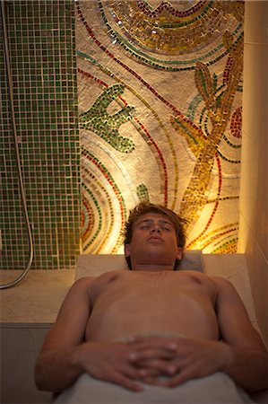 Young man lying on back and relaxing in spa sauna Stock Photo - Premium Royalty-Free, Code: 649-07585300