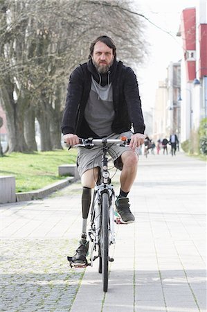 prosthesis - Portrait of man with prosthesis leg cycling Stock Photo - Premium Royalty-Free, Code: 649-07585350