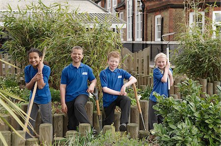 environmental conservation - Portrait of four school children with gardening tools Stock Photo - Premium Royalty-Free, Code: 649-07585414
