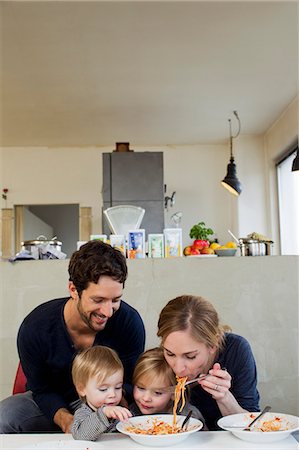 Family with two daughters eating spaghetti meal Stock Photo - Premium Royalty-Free, Code: 649-07585441