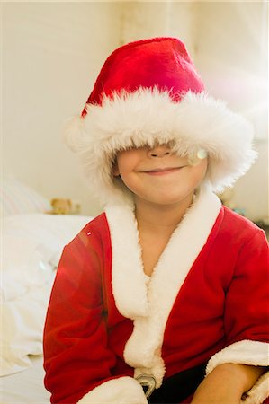 portrait of a young boy - Portrait of young boy hidden by santa outfit cap Stock Photo - Premium Royalty-Free, Code: 649-07585487