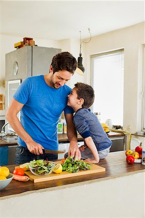 family in front of home - Father and young son preparing vegetables in kitchen Stock Photo - Premium Royalty-Free, Code: 649-07585481