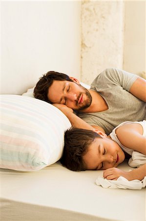 sleepwear - Father and young son asleep in bed Stock Photo - Premium Royalty-Free, Code: 649-07585490