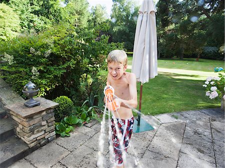 squirting - Boy squirting hose Stock Photo - Premium Royalty-Free, Code: 649-07585493