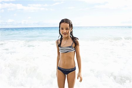 swimsuit on girl - Girl playing in sea, looking at camera Stock Photo - Premium Royalty-Free, Code: 649-07585552