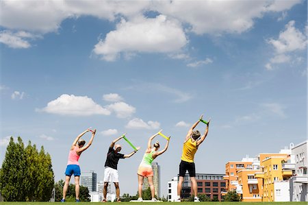 simsearch:649-07585305,k - Four people exercising with rubber bands in park Stock Photo - Premium Royalty-Free, Code: 649-07596107