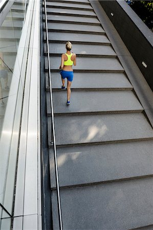people in yellow - Jogger running up steps Stock Photo - Premium Royalty-Free, Code: 649-07596161