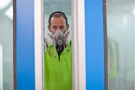 factory model release not child not woman - Portrait of carpenter in spray painting workshop doorway Stock Photo - Premium Royalty-Free, Code: 649-07596219