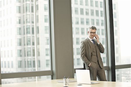 Portrait of businessman in high rise office Stock Photo - Premium Royalty-Free, Code: 649-07596255