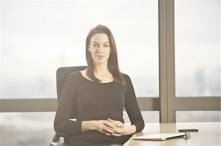 Portrait of businesswoman at office desk Stock Photo - Premium Royalty-Free, Code: 649-07596253