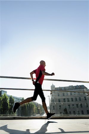 running side view - Runner crossing bridge, Munich, Germany Stock Photo - Premium Royalty-Free, Code: 649-07596273