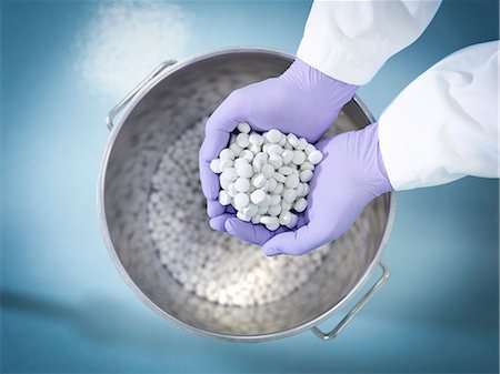 drugs - Close up of worker inspecting tablets in pharmaceutical factory Stock Photo - Premium Royalty-Free, Code: 649-07596703