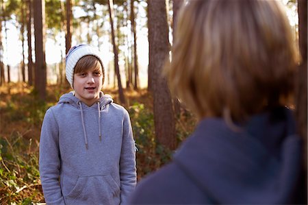 Twin brothers face to face in woods Stock Photo - Premium Royalty-Free, Code: 649-07596712