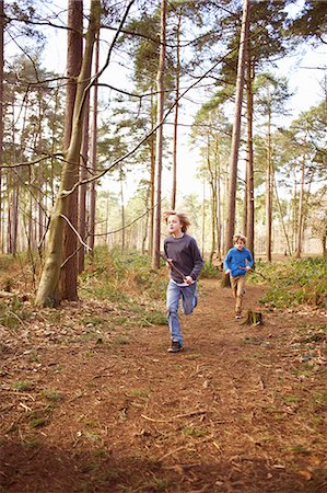 simsearch:614-08876322,k - Twin brothers racing each other through forest Stock Photo - Premium Royalty-Free, Code: 649-07596724