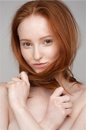 red headed female portrait - Portrait of young woman, hands in hair Stock Photo - Premium Royalty-Free, Code: 649-07647867