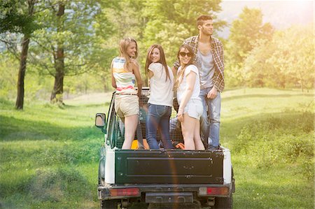 free cool people - Friends standing on back of off road vehicle Stock Photo - Premium Royalty-Free, Code: 649-07648545