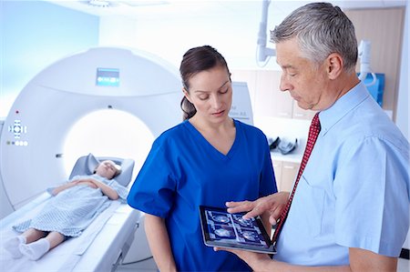 simsearch:649-07709934,k - Girl in CT scanner, doctor and radiographer looking at scan on digital tablet Stock Photo - Premium Royalty-Free, Code: 649-07709923