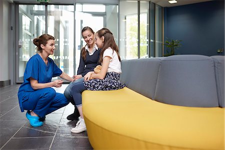 simsearch:649-07709923,k - Nurse speaking to girl in hospital waiting room Stock Photo - Premium Royalty-Free, Code: 649-07709953