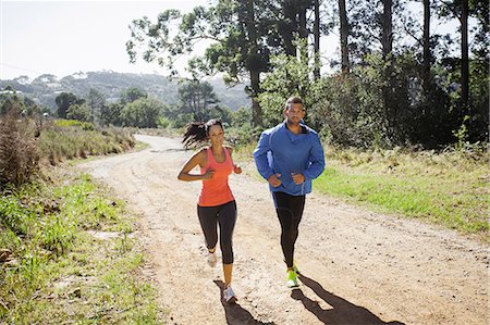 simsearch:649-07709997,k - Young couple jogging in forest Stock Photo - Premium Royalty-Free, Code: 649-07710114