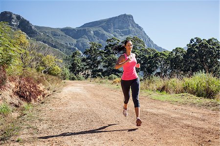 simsearch:649-07710114,k - Young woman jogging in forest Photographie de stock - Premium Libres de Droits, Code: 649-07710118