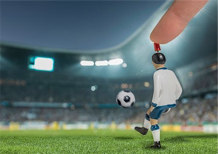 performance sports - Digitally generated image of soccer player kicking ball in floodlit stadium Stock Photo - Premium Royalty-Free, Code: 649-07710194