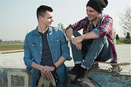 denims fashion - Young men sitting together at skatepark Stock Photo - Premium Royalty-Free, Code: 649-07710446