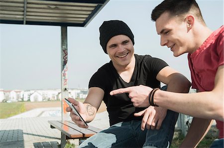 skateboarder - Young men in skatepark, using smartphone Stock Photo - Premium Royalty-Free, Code: 649-07710455